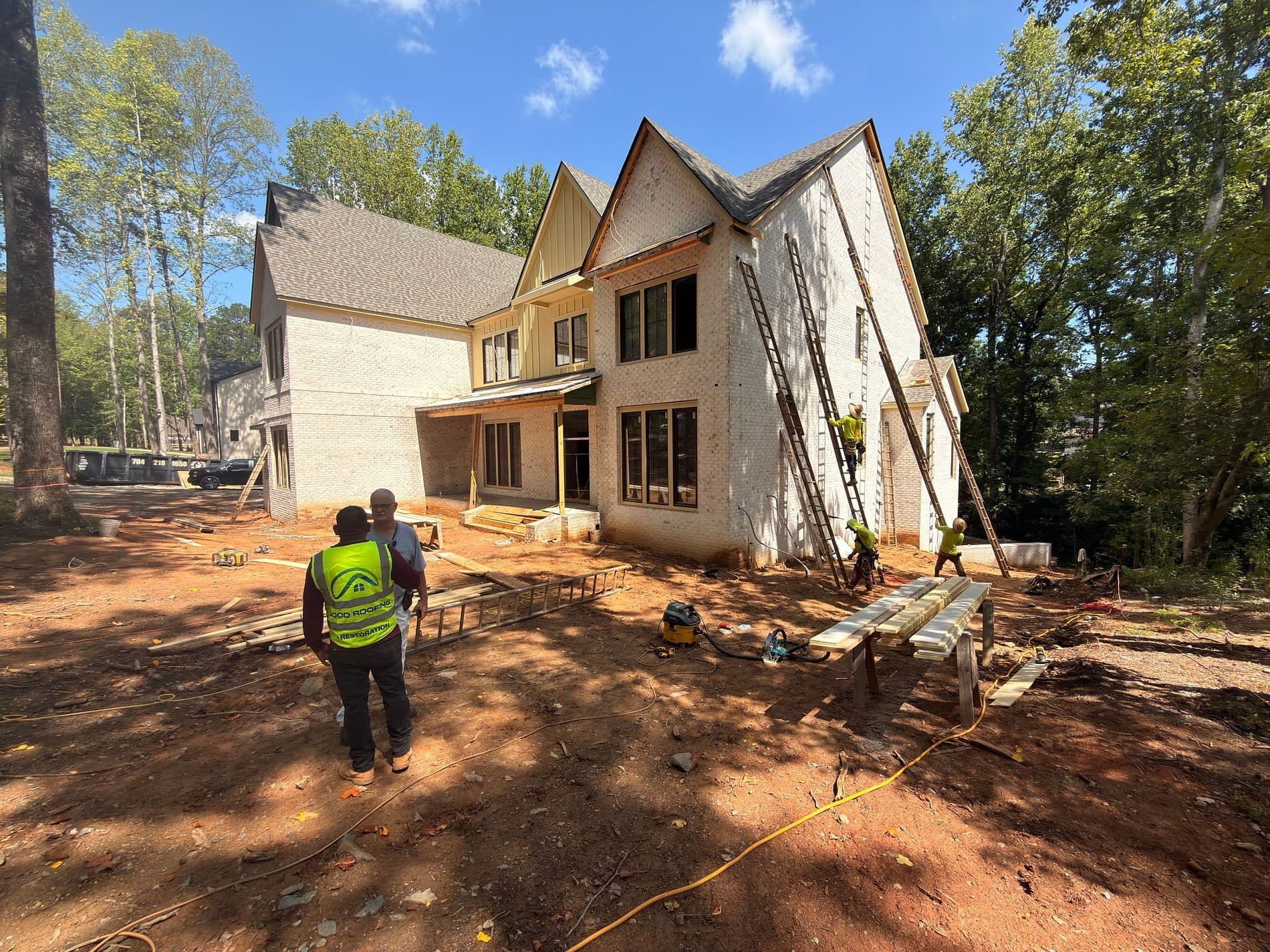 Good Roofing crew framing a home addition