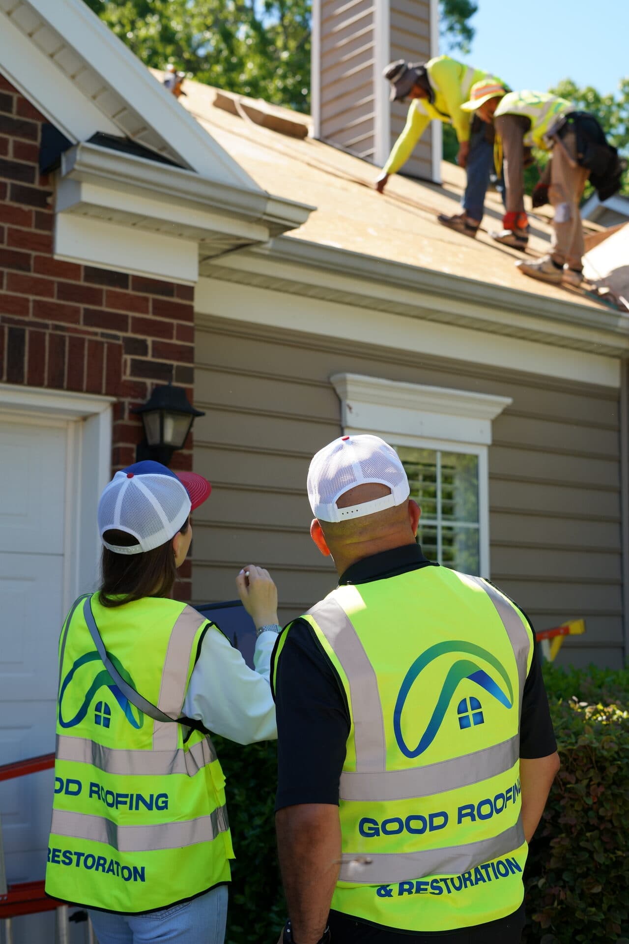 Good Roofing crew working on home exterior siding